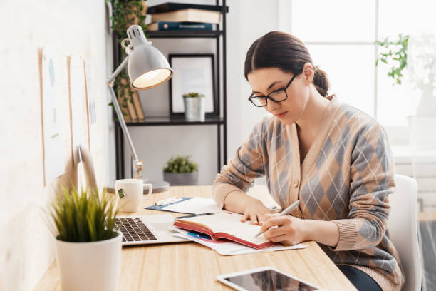 istock woman working on a laptop at home. 1247001457