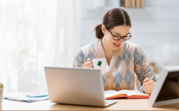 istock woman working on a laptop at home. 1247001463