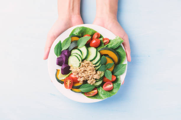 istock Salad quinoa with vegetables on plate, Vegan food 1247002080