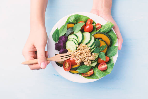 istock Salad quinoa with vegetables on plate, Vegan food 1247002113