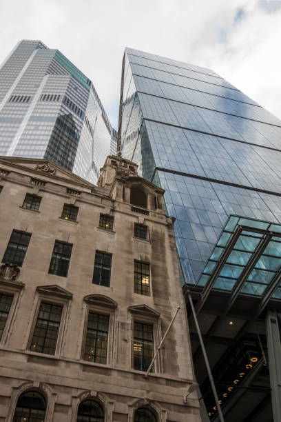 istock Evolving architecture. Old and modern design inner-city buildings blending together. 1247002231