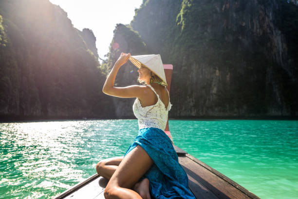 istock Beautiful woman on a long-tail boat in Thailand 1247003437
