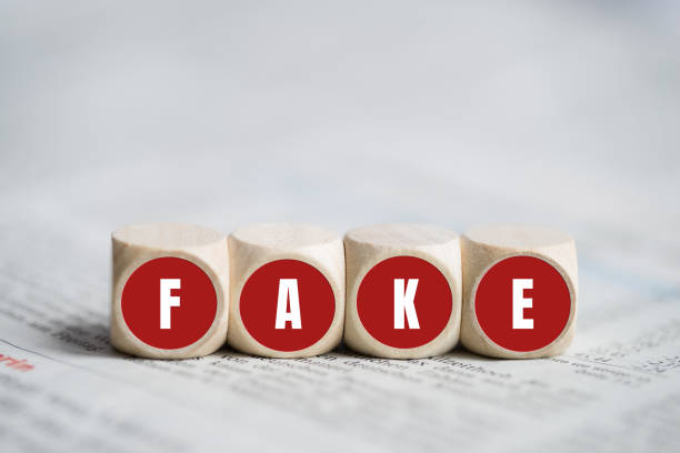 istock cubes with the word FAKE on newspaper 1247009017