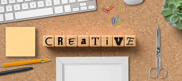 istock cubes with the word CREATIVITY and office items 1247011340