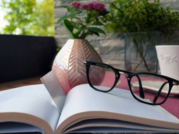 istock Eyeglasses and a book on a coffee table on the balcony 1247012550