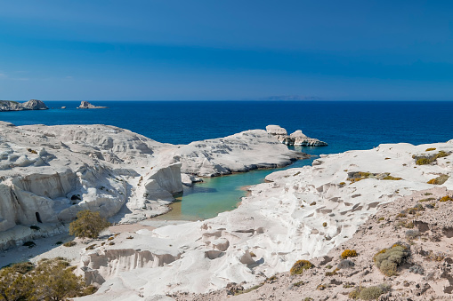Amazing landscape with white volcanic rocks at Sarakiniko beach. Turquoise Aegean sea and blue sunny sky. Unique mediterranean nature of Milos island, Greece. Travel destination and vacation paradise