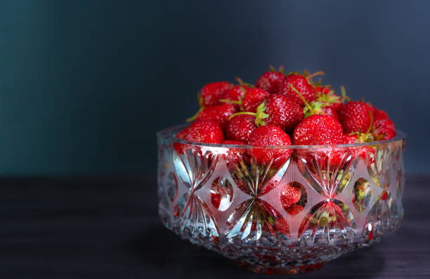 istock Ripe strawberries on a black background 1247012987