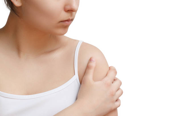 istock a woman massages her arm with a sick shoulder. front view. isolated on white background 1247014393