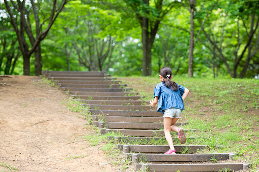 Girl climbing stairs in the park