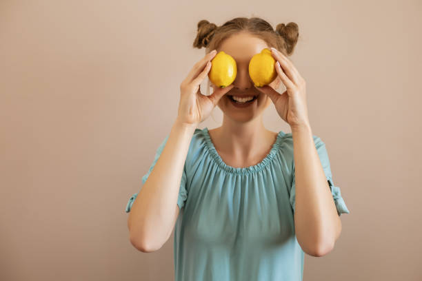 istock Woman holding lemon 1247022884