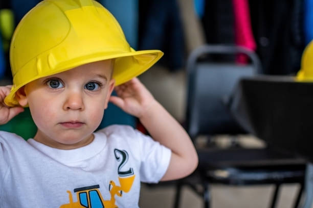Young boy with a hardhat during his 2nd anniversary party.