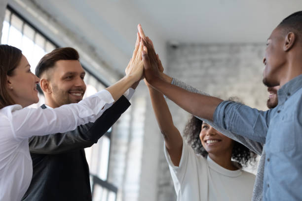 istock Close up happy successful diverse employees team giving high five 1247026199