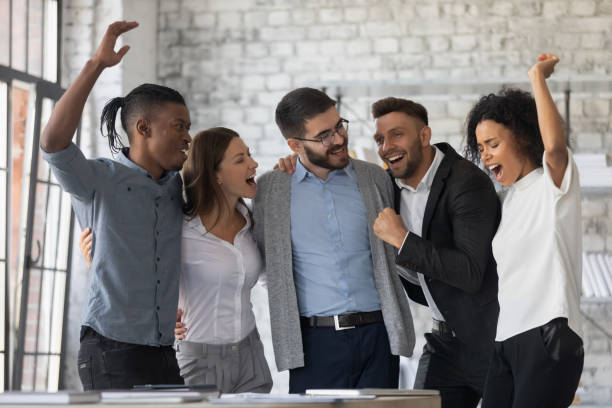 istock Excited diverse colleagues celebrating teamwork success, business achievement 1247026207
