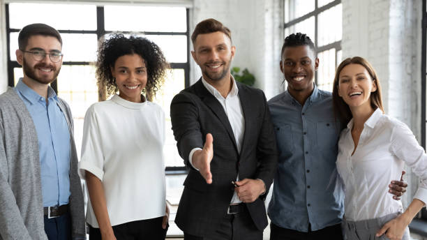 istock Smiling businessman team leader offering hand for handshake 1247026223
