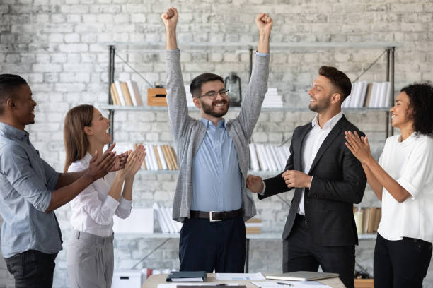 istock Diverse employees congratulating successful colleague with promotion 1247026319