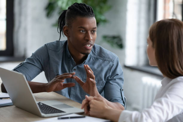 istock Confident African American mentor teaching new employee, giving instructions 1247026323