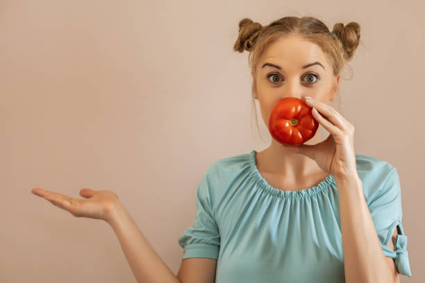 istock Woman holding tomato 1247027680