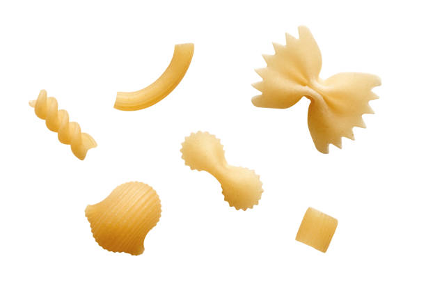 Various raw pasta isolated on white background Various raw pasta isolated on white background. Farfalle, rotini, ziti rigati, pipette rigate; ditalini and farfalline. carbohydrate food type photos stock pictures, royalty-free photos & images