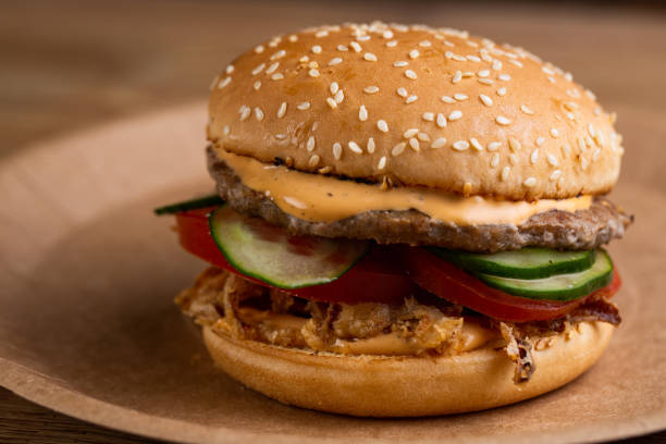 istock cheeseburger with beef patty, fried onions, fresh vegetables and creamy sauce 1247032452