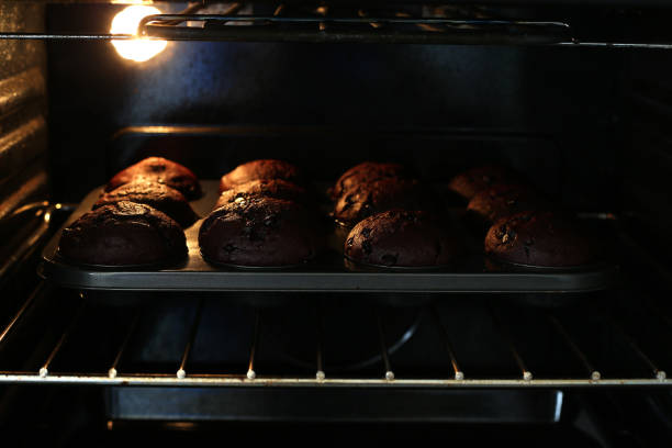 istock Chocolate muffins baking in a modern oven 1247037223