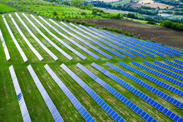 istock Solar panels fields on the green hills 1247045388