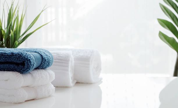 istock Clean towels and houseplant on white table. 1247045906