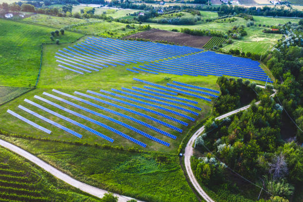 istock Solar panels fields on the green hills 1247045923