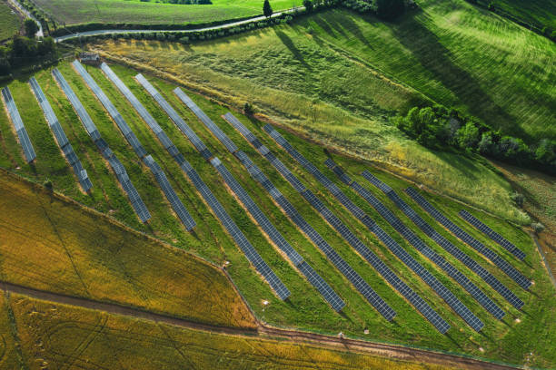 istock Solar panels fields on the green hills 1247046626