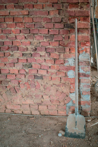 istock on building site there is a shovel on a brick wall 1247048362