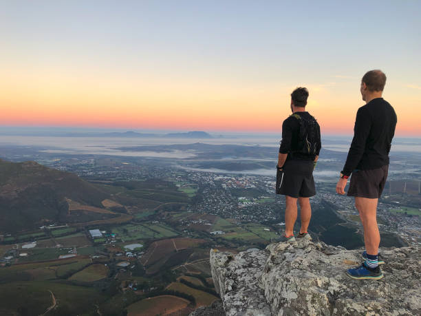 istock Two Runners Mountain Summit Reward Looking away 1247049957