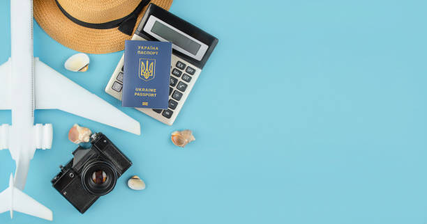 istock Summer accessories with a Ukrainian passport on a blue background with empty space for text. Travel concept, vacation. Summer vacation. View from above. 1247050342