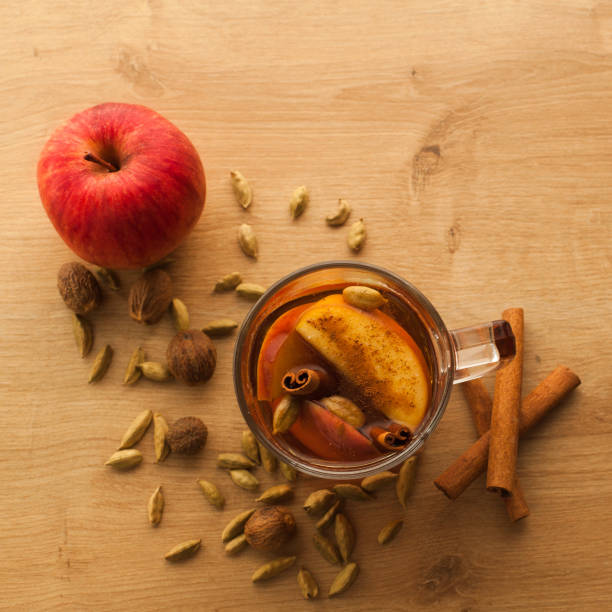 Hot tea with cardamom and cinnamon with apple flavor stock photo