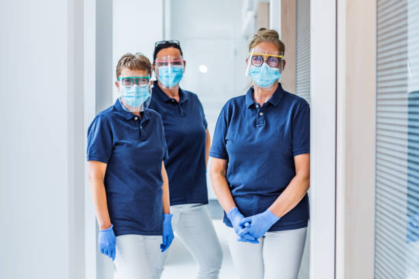 three female medical assistants in a surgery - dentist office nurse doctors office blond hair imagens e fotografias de stock