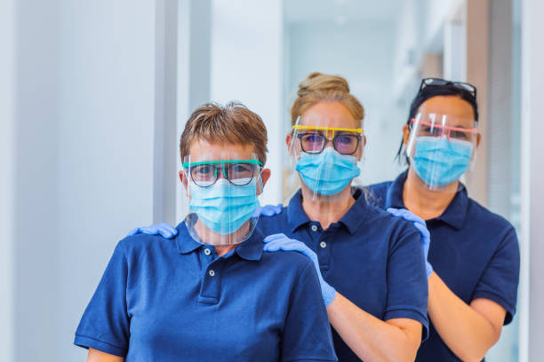 three female medical assistants in a surgery - dentist office nurse doctors office blond hair imagens e fotografias de stock