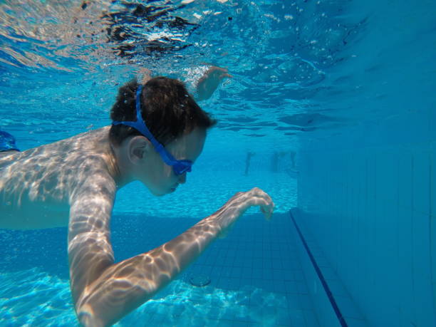 istock Child boy swimming pool water playing summer vacation fun 1247056518