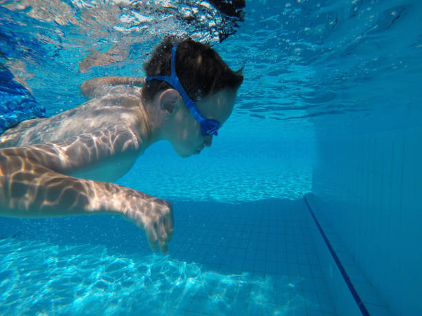 istock Child boy swimming pool water playing summer vacation fun 1247058645
