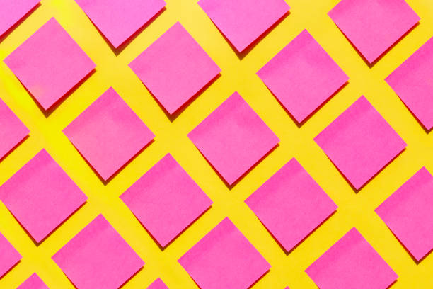 pink sticky notes on yellow background - adhesive note note pad message pad yellow imagens e fotografias de stock