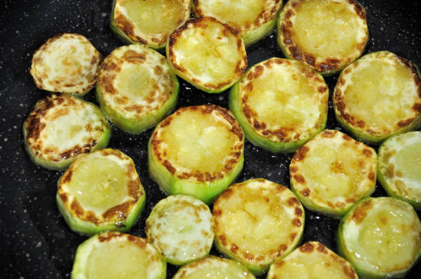 istock young zucchini fried in olive oil 1247073632