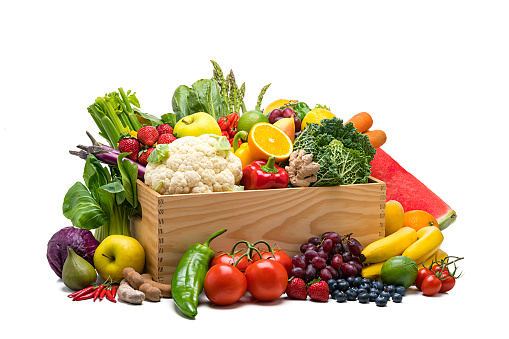 Healthy food: fresh organic fruits and vegetables in a crate isolated on white background. Fruits and vegetables included in the composition are oranges. apples, fig, tamarind, blue berries, grape, lime, lemon, banana, watermelon, strawberries, pears, kale, tomatoes, squash, asparagus, Bok choy, celery, eggplant, carrots, lettuce, edible mushrooms, bell peppers cauliflower, ginger, corn, among others. High resolution studio digital capture taken with Sony A7rII and Sony FE 90mm f2.8 macro G OSS lens
