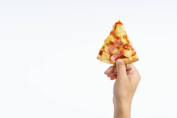 Hand holding hawaiian pizza