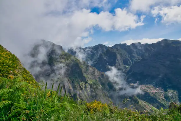 View from the hiking trail at the Boca da Corrida belvedere on the Encumeada pass on Madeira Island, Portugal in summer, View to the village of Curral das Freiras