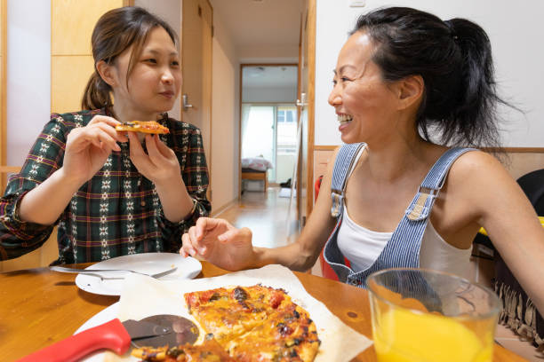 istock Female friends eating home made pizza 1247079944