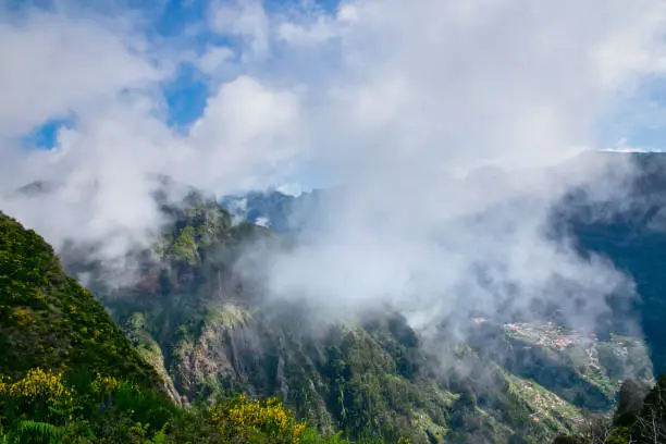 View from the hiking trail at the Boca da Corrida belvedere on the Encumeada pass on Madeira Island, Portugal in summer, View to the village of Curral das Freiras