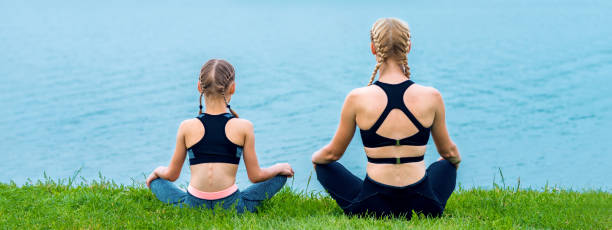 istock Mother and daughter doing yoga exercises 1247105961