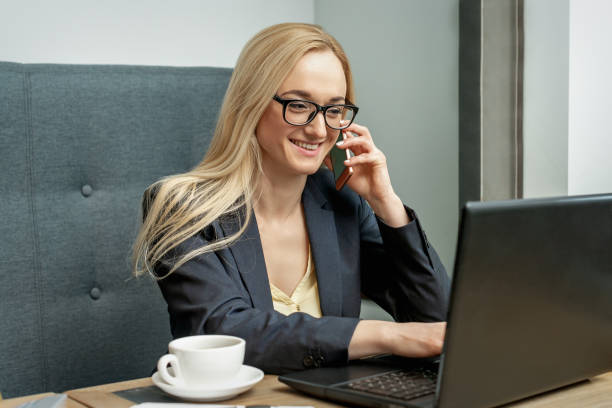istock Young woman is talking by cell phone in office. 1247109823