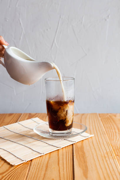 istock Milk is poured into iced coffee 1247123370