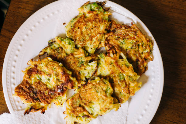 istock Vegetable Fritters Overlapping on a White Plate on a Wood Background 1247123903