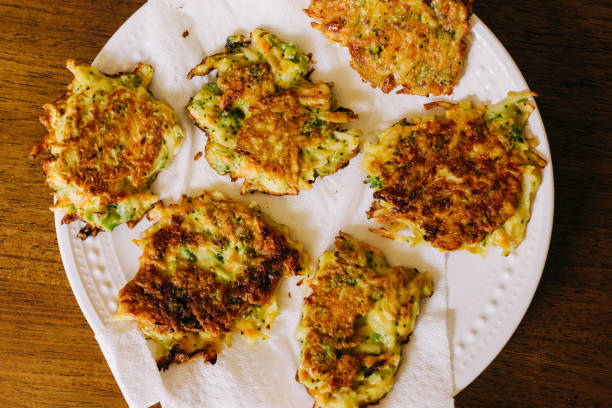 istock Pan Fried Vegetable Fritters on a White Plate on a Wood Table. 1247124428