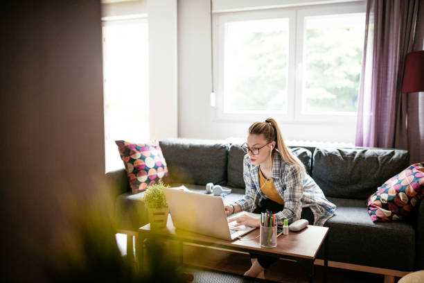 istock Gen-Z woman working on laptop at home and attending e-learning course 1247152251