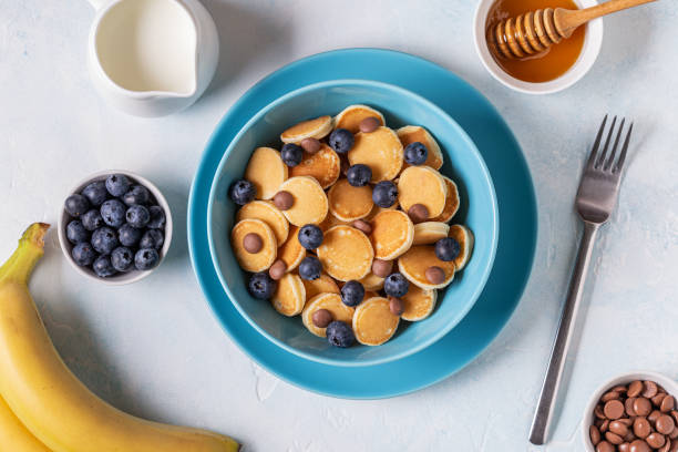 istock Trendy breakfast with mini pancakes, blueberries and chocolate chips 1247153269